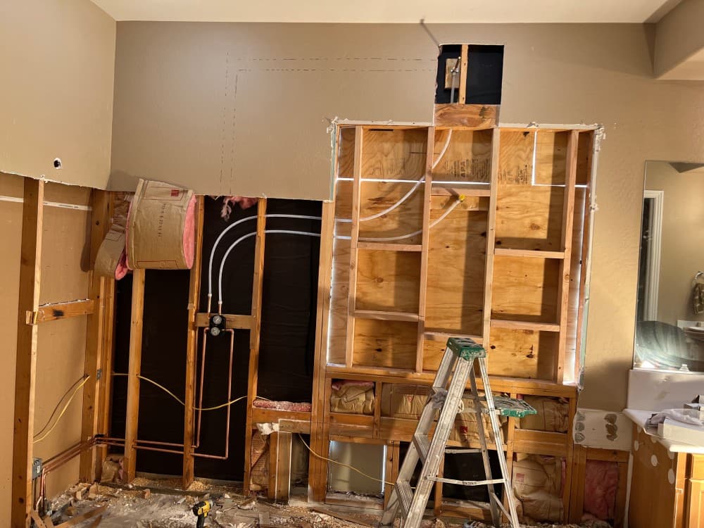 Whole-house repipe in progress with new PEX water lines run through exposed framing on a Scottsdale home.